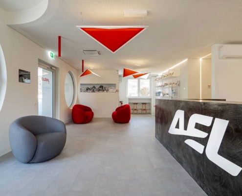 Recepción moderna de la academia Aelo Swiss, con diseño de interiores y asientos cómodos.